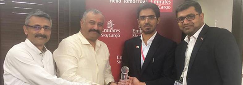 EFL staff holding award from Emirates