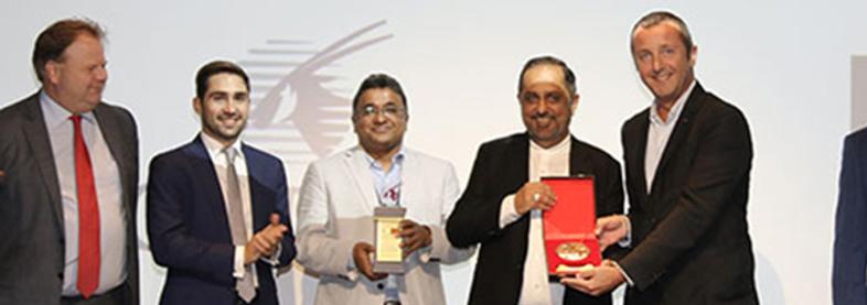 EFL staff holding award from Qatar Airways