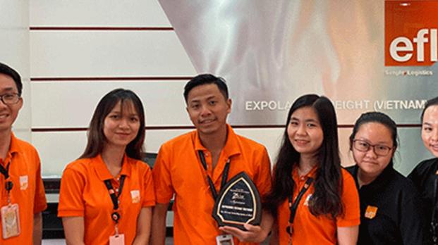 EFL staff holding award