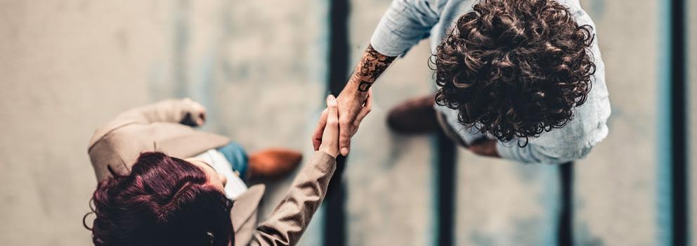 Business people shaking hands viewed from above