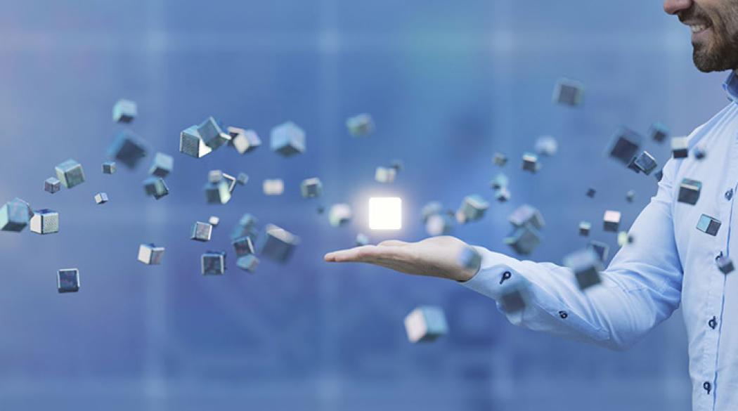 Man balancing floating silver cubes