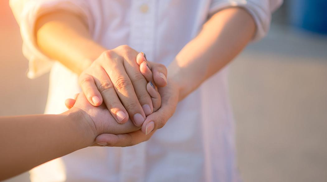 Mother holding child's hand